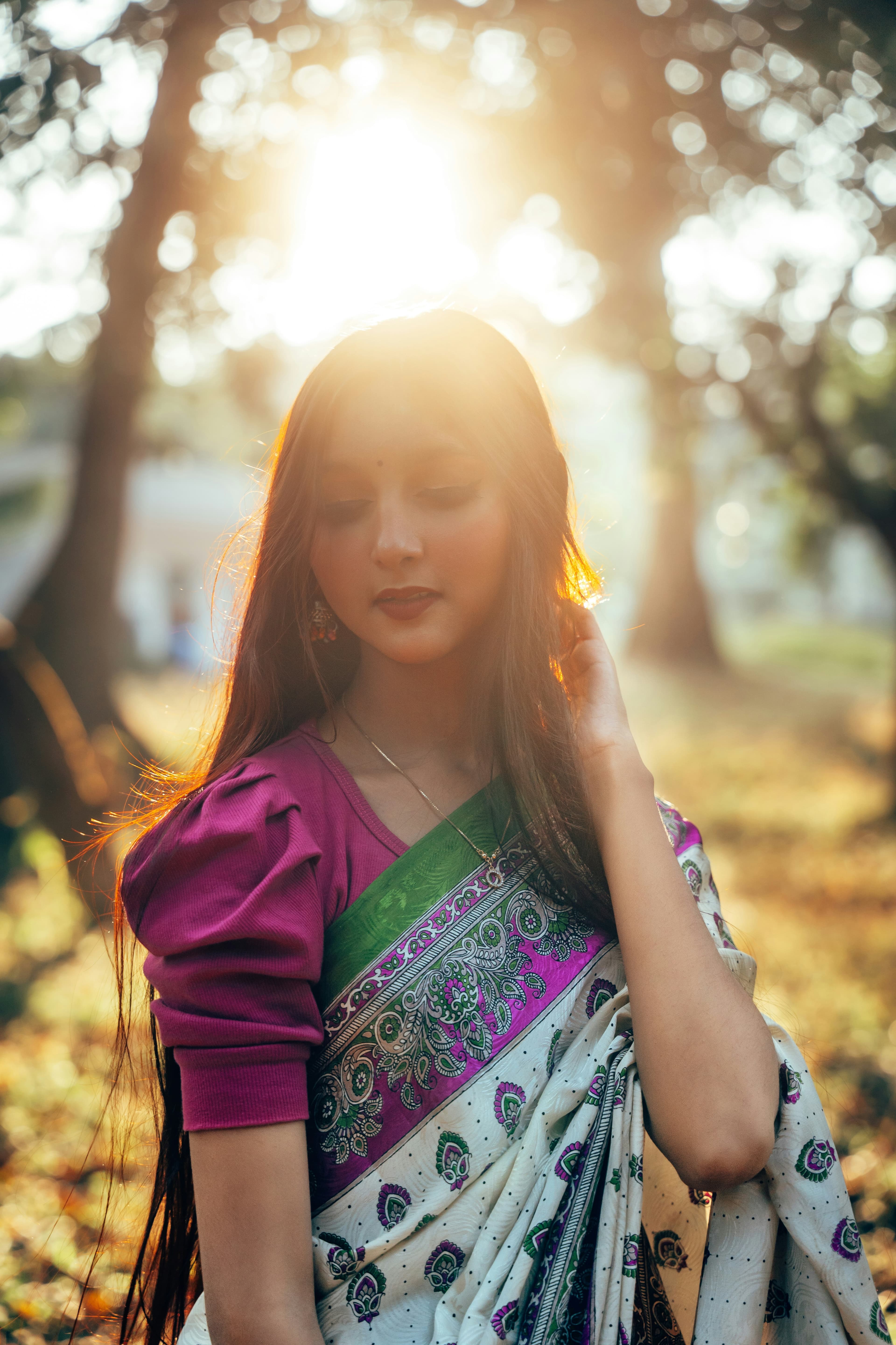 Woman in a printed silk saree, lit by golden evening sun