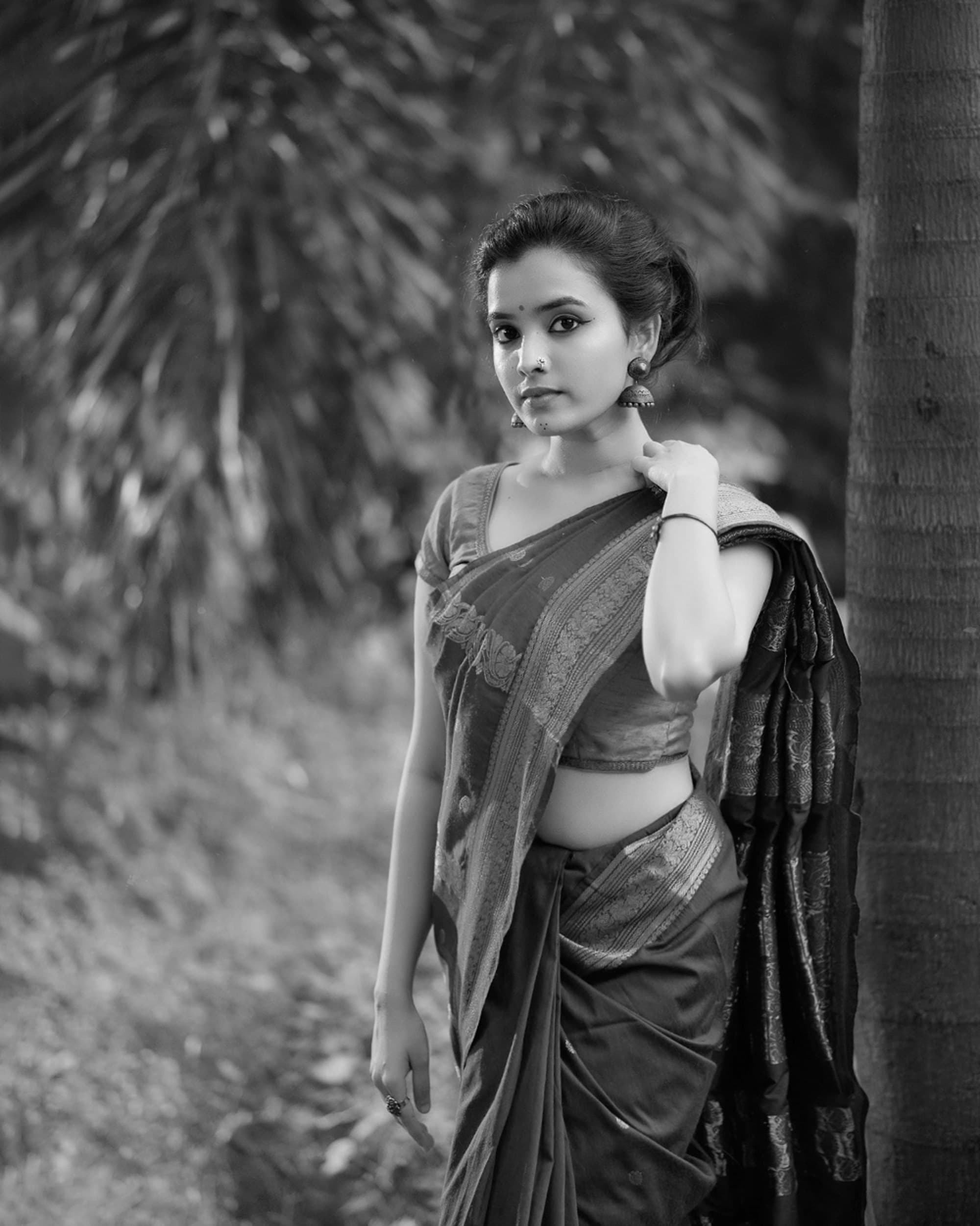 Woman in a silk saree with a woven temple border, in black and white